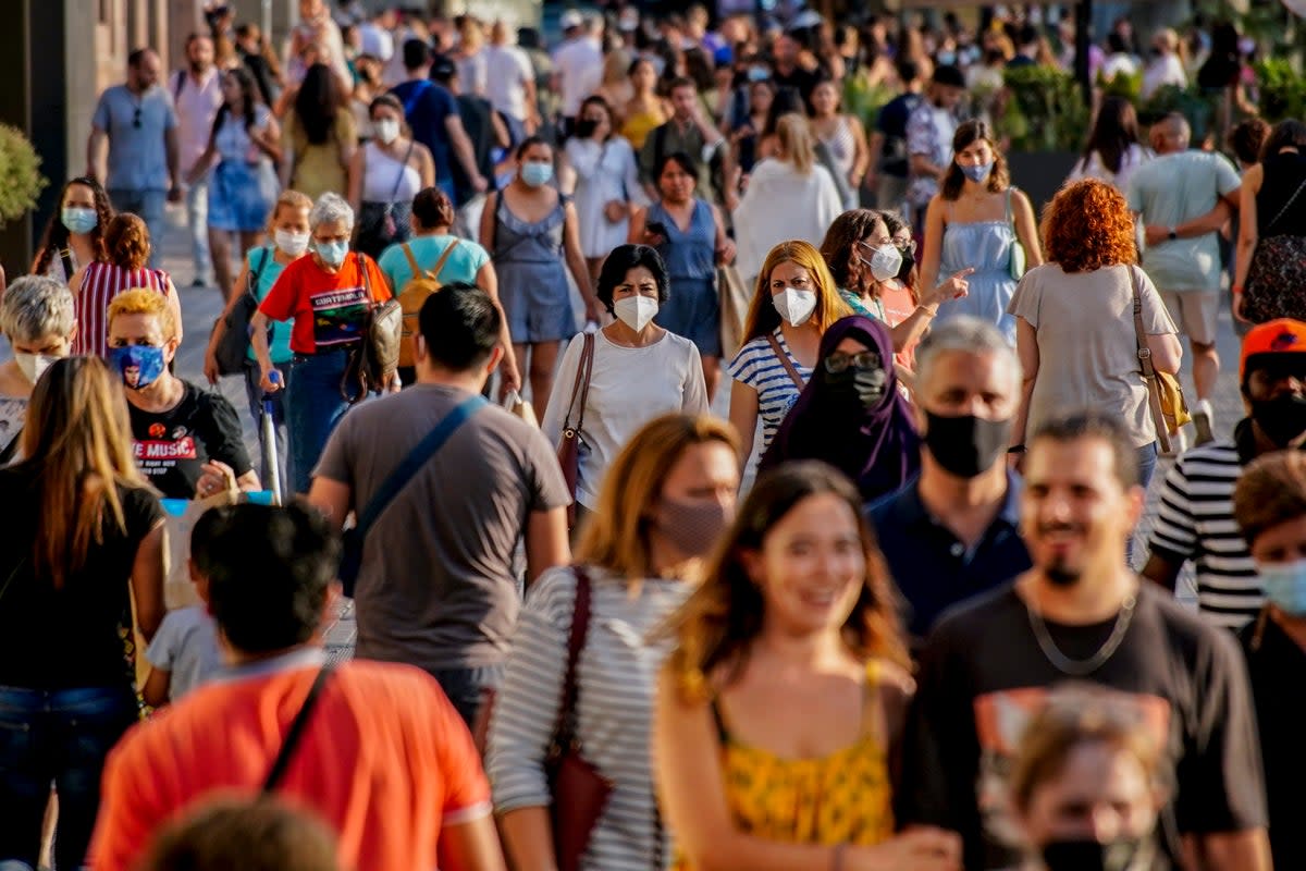 People in Barcelona wearing face masks during the summer of 2021   (AP)