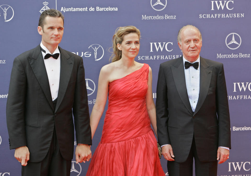 FILE - In this May 22, 2006 file photo, Spain's King Juan Carlos, right arrives with his daughter, Princess Cristina, centre and her husband, Inaki Urdangarin, for the Laureus World Sports Awards in Barcelona, Spain. On Wednesday April 3, 2013 a Spanish court named the king’s daughter Princess Cristina as a suspect in a corruption case involving her husband and will be called in for questioning on April 27.(AP Photo/Jasper Juinen, File)