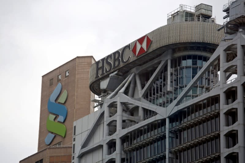 FILE PHOTO: FILE PHOTO: Logos of HSBC and Standard Chartered banks are seen at their headquarters in Hong Kong