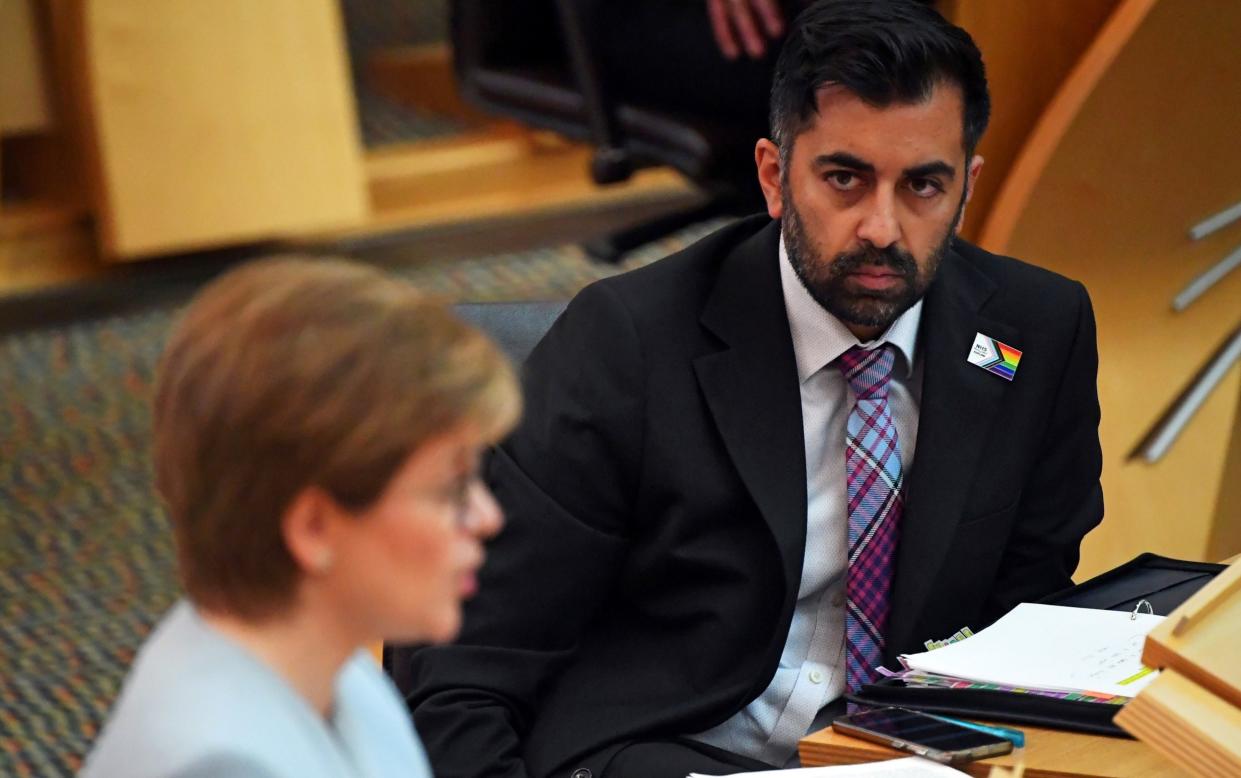 Humza Yousaf watches Nicola Sturgeon speak