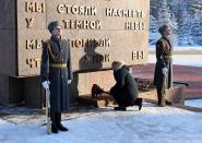 Russian President Vladimir Putin places flowers on a monument at Nevsky Pyatachok near Kirovsk, Russia, Sunday Jan. 27, 2019. The Russian city of St. Petersburg marked the 75th anniversary of the end of the World War II siege by Nazi forces. The siege of the city, then called Leningrad, lasted nearly two and a half years until the Soviet Army drove the Nazis away on Jan. 27, 1944. (Mikhail Klimentyev, Sputnik, Kremlin Pool Photo via AP)