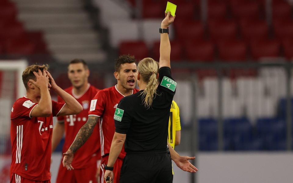 Steinhaus hands Lucas Hernandez a yellow card in her final game - GETTY IMAGES