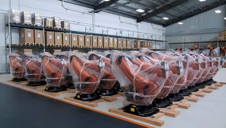 Robots covered in plastic sheets are seen at a plant of Kuka Robotics in Shanghai August 13, 2014. REUTERS/Pete Sweeney