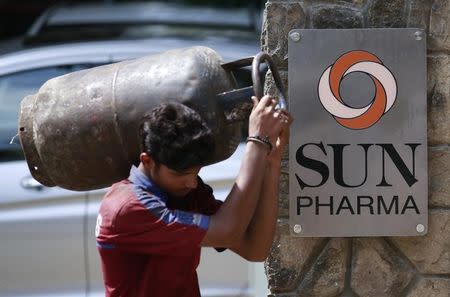 A man carrying a gas cylinder walks out of the research and development centre of Sun Pharmaceutical Industries Ltd in Mumbai May 29, 2014. REUTERS/Danish Siddiqui