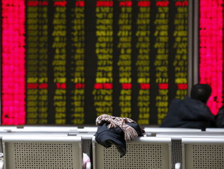 An investor's coat and scarf is placed on a chair in front of an electronic screen showing stock information at a brokerage house in Beijing, China, January 27, 2016. REUTERS/Kim Kyung-Hoon