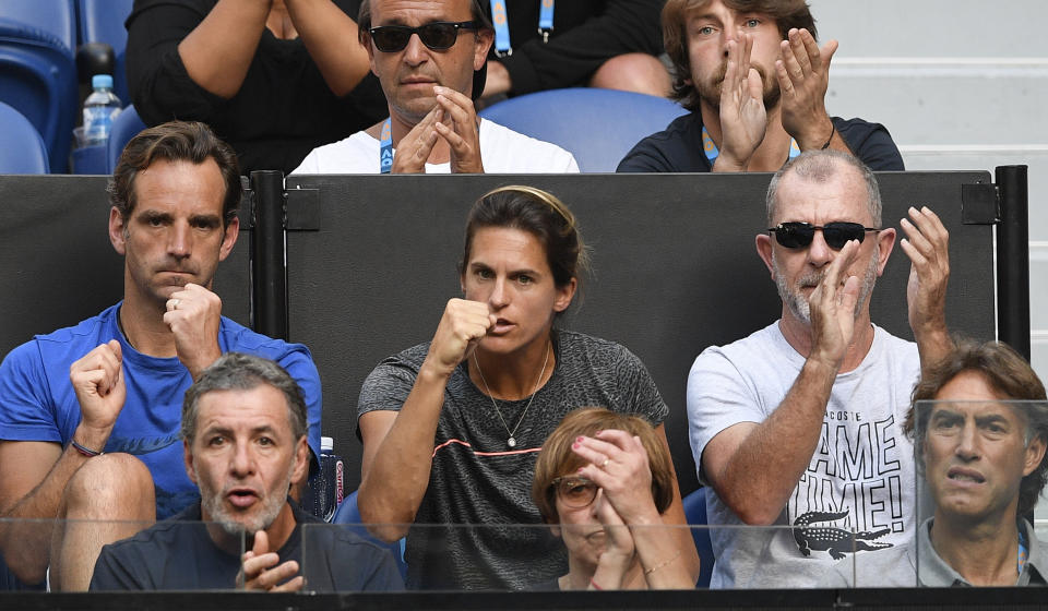 Amelie Mauresmo, center, coach of France's Lucas Pouille, watches from the players box during his quarterfinal match against Canada's Milos Raonic at the Australian Open tennis championships in Melbourne, Australia, Wednesday, Jan. 23, 2019. (AP Photo/Andy Brownbill)
