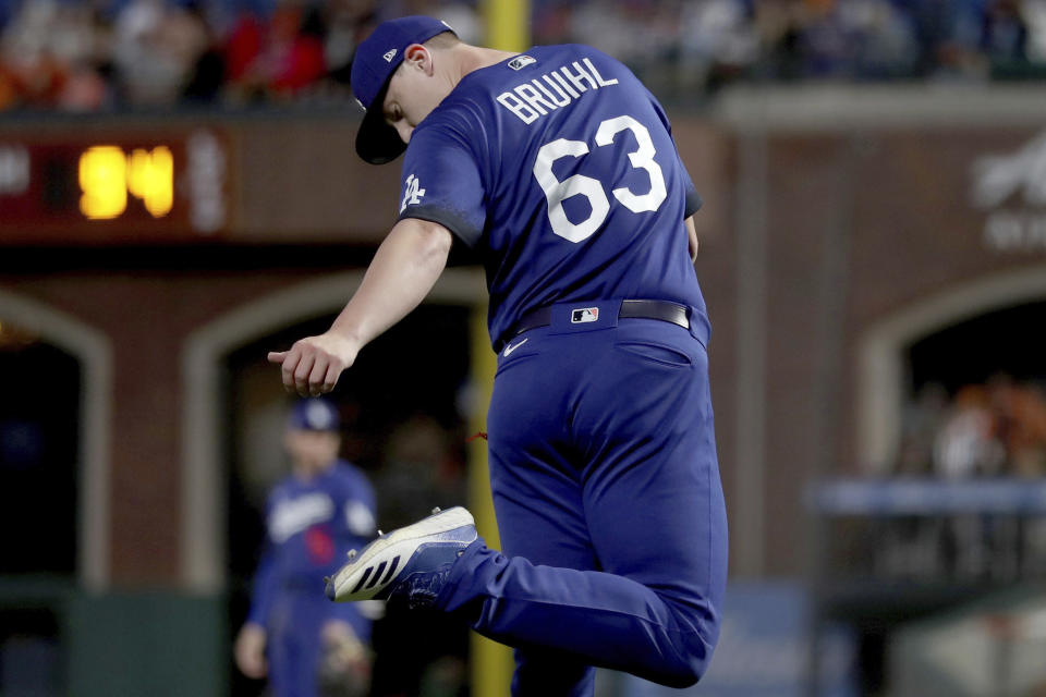 Los Angeles Dodgers' Justin Bruihl (63) checks his cleats after a throwing error during the fifth inning of the team's baseball game against the San Francisco Giants in San Francisco, Friday, June 10, 2022. (AP Photo/Jed Jacobsohn)