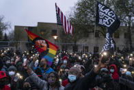 Demonstrators flash their mobile phone lights as they gather outside the Brooklyn Center Police Department to protest Sunday's fatal shooting of Daunte Wright during a traffic stop, Tuesday, April 13, 2021, in Brooklyn Center, Minn. (AP Photo/John Minchillo)