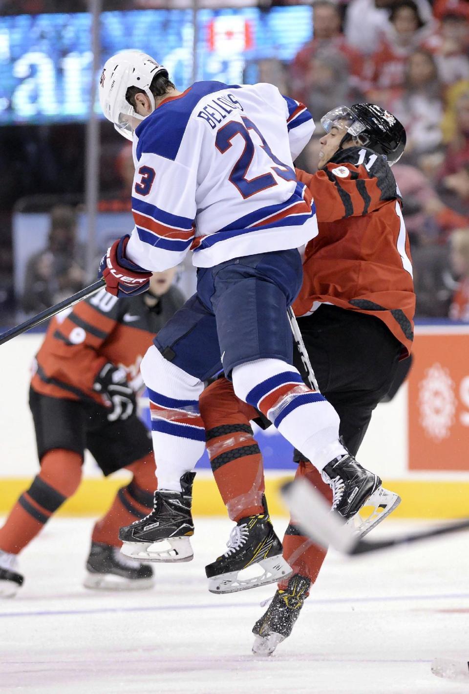 United States forward Kieffer Bellows (23) cehcks Canada forward Mathieu Joseph (11) during the first period of a World Junior championships hockey game in Toronto, Saturday, Dec. 31, 2016. (Nathan Denette/The Canadian Press via AP)