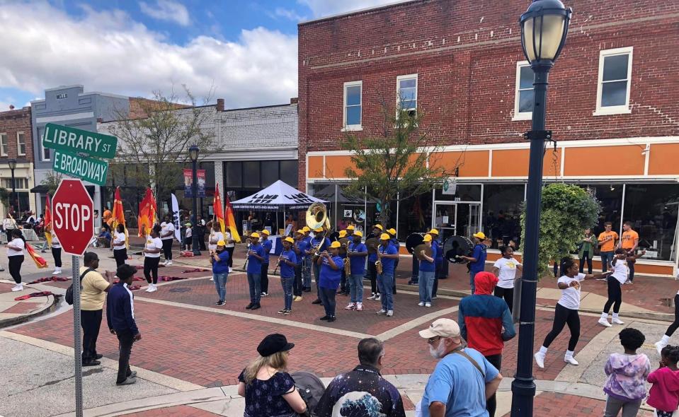 Lamb Arts Fest attendees watch the Hopewell High School Blue Devils Marching Band perform on Oct. 1, 2022.