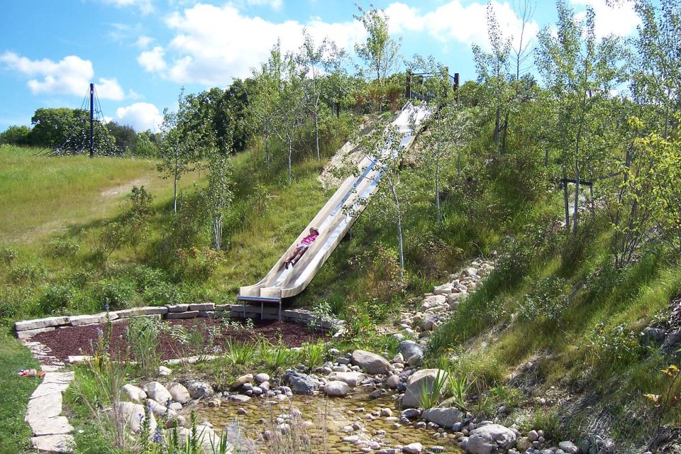 The slides built into a hill at Fox River Park are the most popular features at the natural play area.