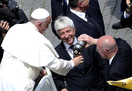 Pope Francis drinks mate, an Argentinian drink, during the Palm Sunday mass at Saint Peter's Square at the Vatican April 13, 2014. REUTERS/Alessandro Bianchi