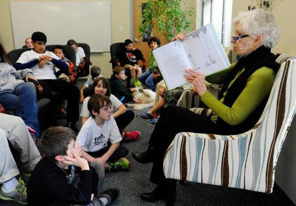 Dale Halton shows the illustrations in the book The Giving Tree while reading to 32 members of the First thru Fifth grade in the Dale F. Halton Lower School at The John Crosland School on Wednesday, February 4, 2015. At Christmas, the lower school children made ornaments for her, hung them on a 3-foot Norfolk pine and gave it to her. She returned to the school with the tree, so she and the students could plant it to "watch it grow, together." After the planting, Halton read The Giving Tree to them. 
