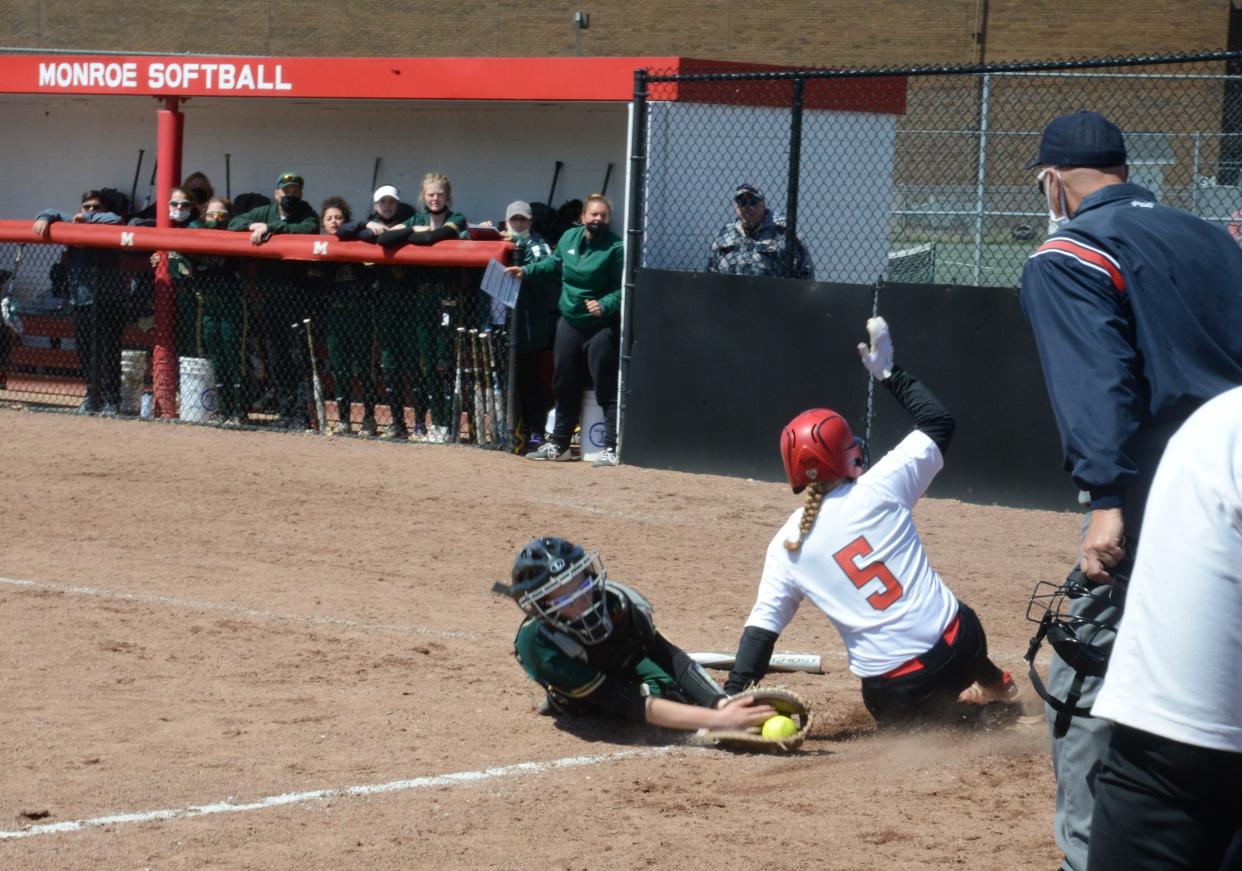 St. Mary Catholic Central catcher Emma Gessner tags out Alana Aulph of Monroe at the plate Saturday.