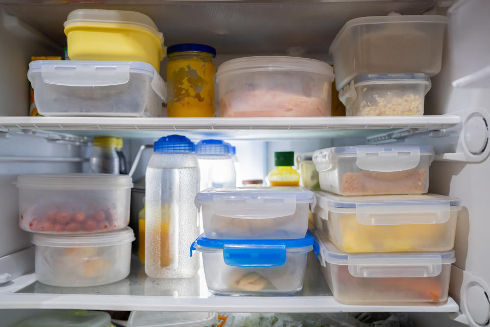 A fridge full of plastic containers filled with food