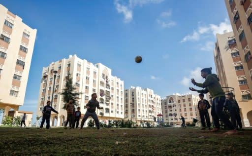 Palestinian children play football in the courtyard of a new residential complex built by Qatar in Khan Yunis in the south of the impoverished Gaza Strip, where its investments have transformed residents' lives