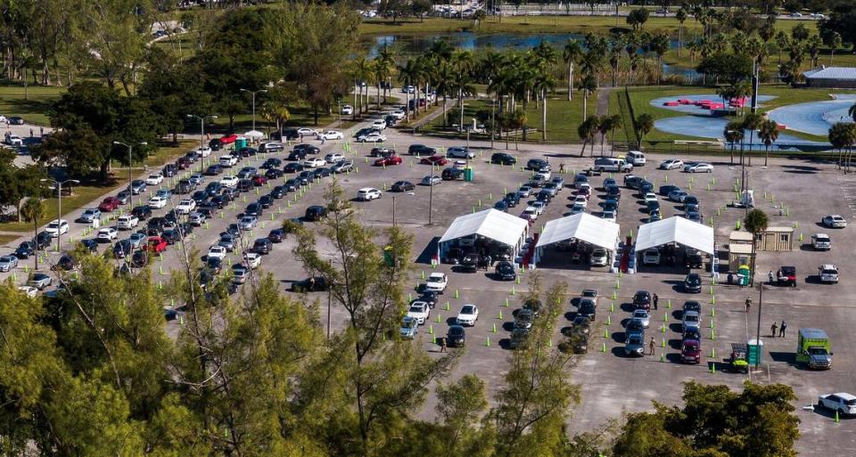 Long lines of cars wait as people with appointments get the COVID vaccine at Tropical Park test site on Saturday, Jan. 9, 2021. The Florida Highway Patrol and Miami-Dade Police urged drivers to avoid a portion of Bird Road because large crowds hoping to get the COVID-19 vaccine at the park led to traffic jams. Coronavirus numbers are surging in Miami-Date County.