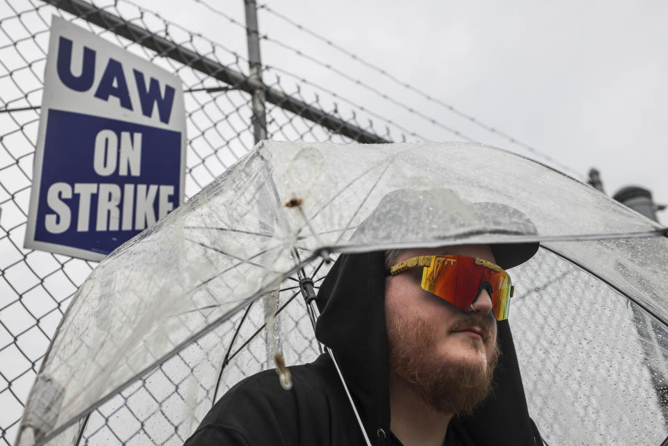 File - United Auto Workers member Matt Shanahan keeps dry while picketing outside Stellantis Toledo Assembly Complex Gate 3 on Stickney Avenue on Oct. 5, 2023 in Toledo, Ohio. From auto production lines to Hollywood, the power of labor unions is back in the national spotlight. (Isaac Ritchey/The Blade via AP, File)