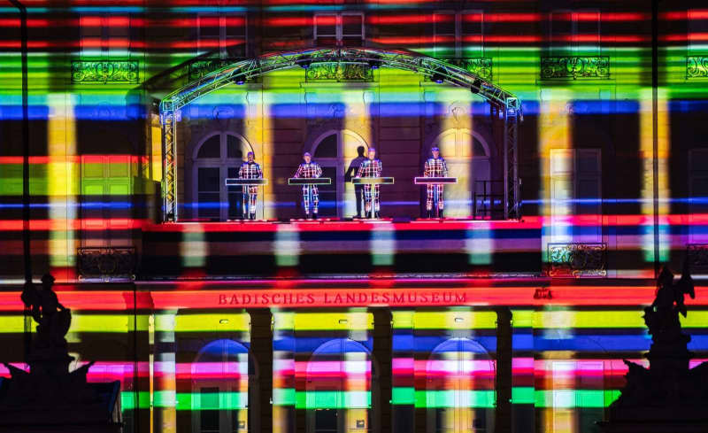 Legendary German electro-pop band Kraftwerk performs on the balcony at Karlsruhe Castle. Uli Deck/dpa