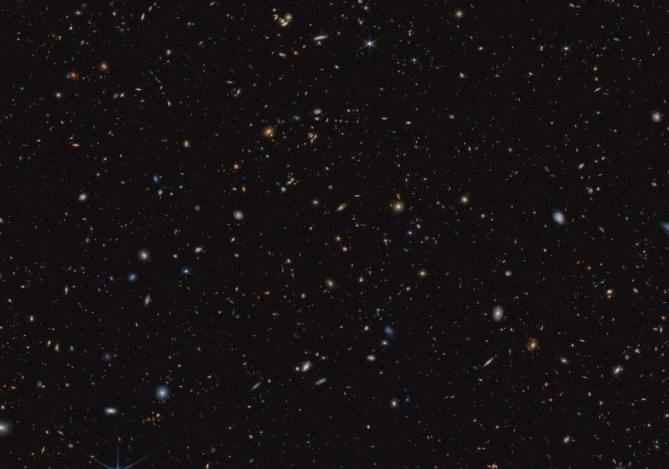 James Webb Space Telescope image showing 45,000 galaxies as small splashes of light against the black void of deep space.