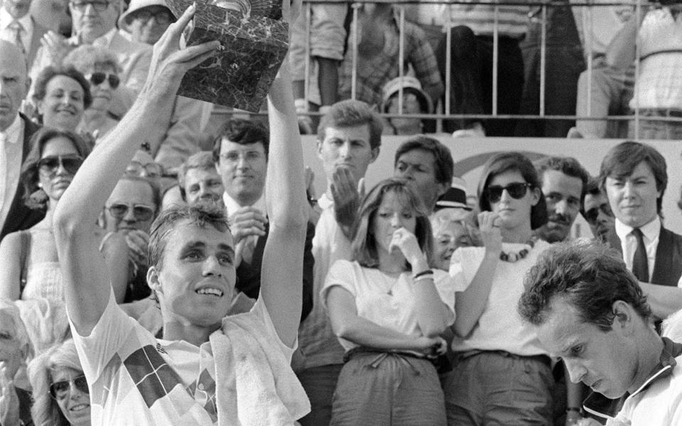 Czech tennis player Ivan Lendl (L) presents the cu...PARIS, FRANCE: Czech tennis player Ivan Lendl (L) presents the cup he just received for his victory against top-seeded McEnroe in the men's final of the French Tennis Open in Roland Garros in Paris 10 June 1984 as American player looks down. Ivan Lendl won 3-6, 2-6, 6-4, 7-5, 7-5 - JOEL ROBINE/Getty Images