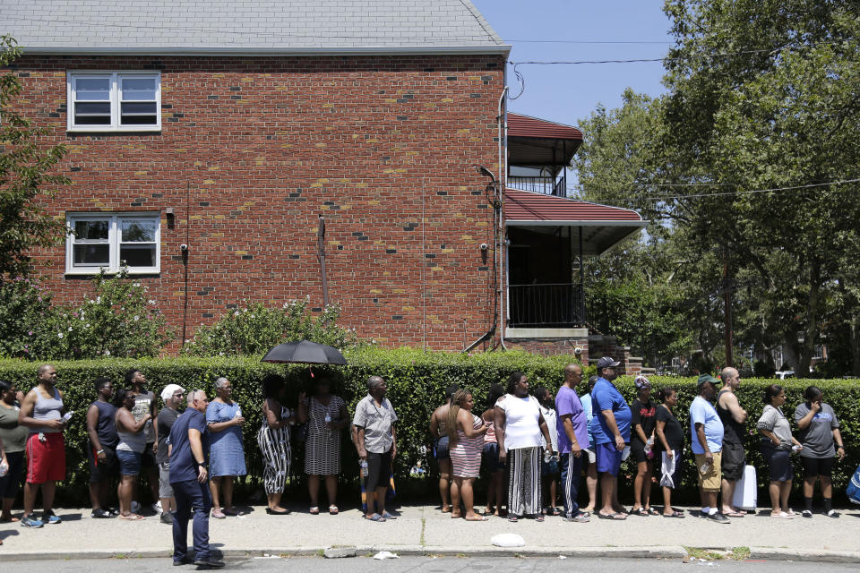 People line up to get dry ice from a Con Edison truck in a neighborhood without power in the Brooklyn borough of New York, Monday, July 22, 2019. Mayor Bill de Blasio called for an investigation Monday of power outages that came at the end of this weekend's oppressive heat, saying he no longer trusts utility Con Edison after it decided to turn off power to thousands of customers. (AP Photo/Seth Wenig)