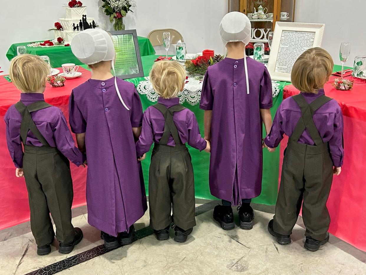 Susan and Ervin’s children take a look at the eck (corner wedding table) at last month’s wedding.