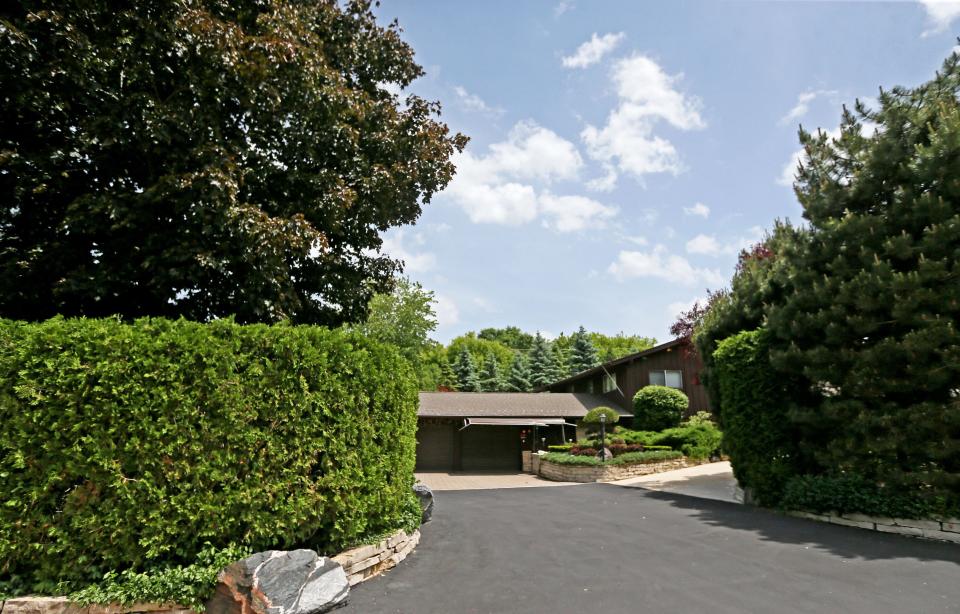 Homeowner and former professional landscaper Bud Wiggins uses trees and berms rather than fencing to provide privacy at his Menomonee Falls home.