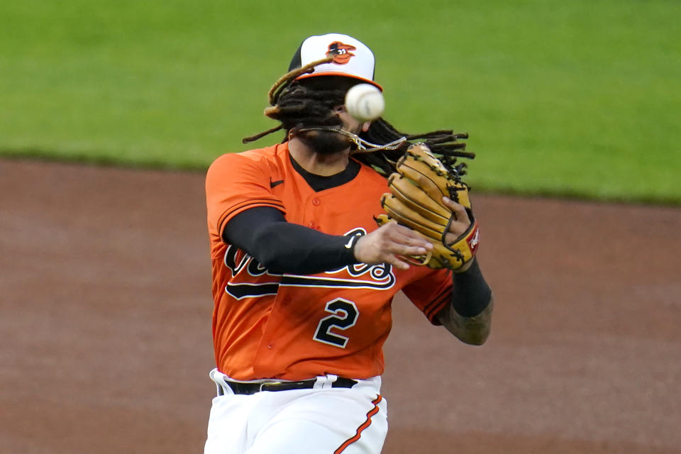 Baltimore Orioles shortstop Freddy Galvis throws to first base while trying to put out Boston Red Sox's Alex Verdugo on a fielders choice ground ball during the first inning of a baseball game, Saturday, April 10, 2021, in Baltimore. (AP Photo/Julio Cortez)