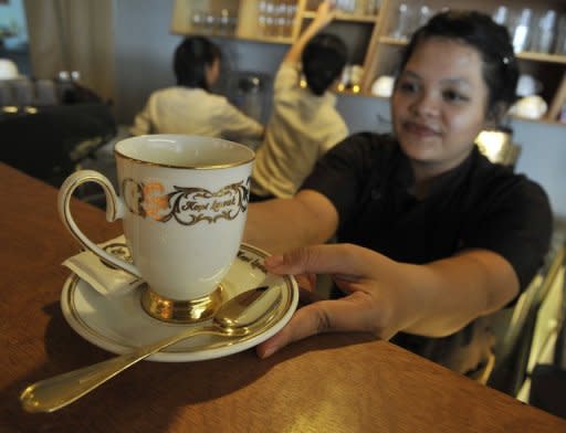A waitress serves up an expensive cup of Kopi Luwak at a local coffee shop in Jakarta. Single cups of the world's most expensive coffee have been known to sell for almost $100 in specialty outlets in London