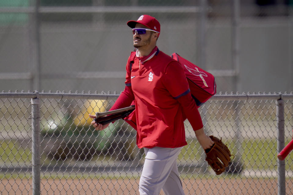 St. Louis Cardinals infielder Nolan Arenado heads out to a spring training baseball practice field Monday, Feb. 22, 2021, in Jupiter, Fla. (AP Photo/Jeff Roberson)