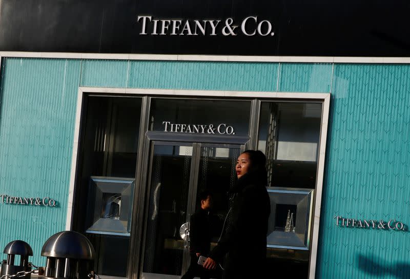 FILE PHOTO: FILE PHOTO: People walk past a boutique of the luxury jewelry retailer Tiffany & Co. in Beijing