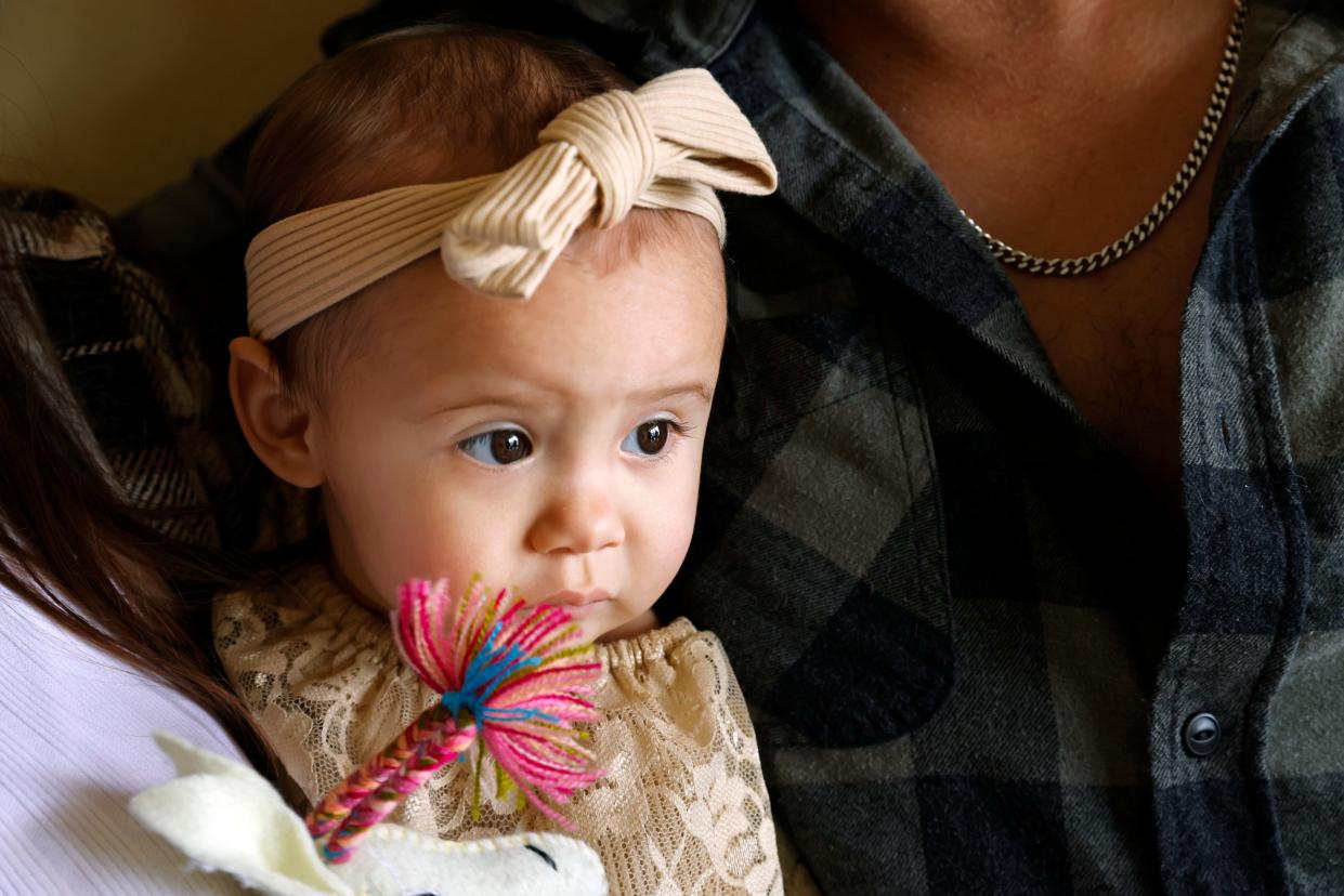 One-year-old Cora Dibert is held by her parents at The Bridge Church, Saturday, Dec. 2, 2023, in Mustang, Okla. No amount of lead exposure is safe for children and the effects on brain development can show up years later, says Dr. Jennifer Sample, a pediatric toxicologist who consults for industry and academics. (AP Photo/Nate Billings)