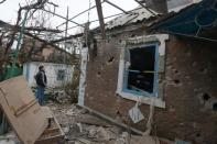 A man looks at a house destroyed after shelling in the eastern Ukrainian city of Donetsk, on February 3, 2015