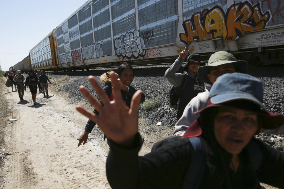 Migrants walk beside a freight train they rode to Ciudad Juarez, Mexico, Thursday, Sept. 28, 2023. (AP Photo/Christian Chavez)