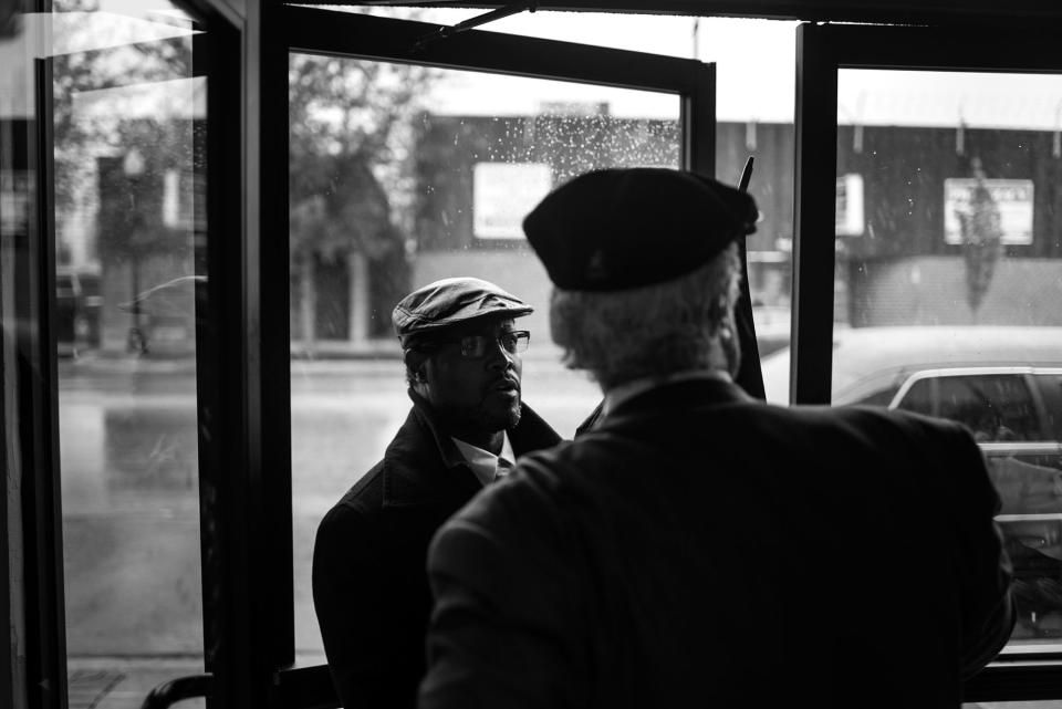 <p>An employee holds a door for Spencer Leak Sr as he heads to his fourth funeral of the day on a recent Saturday. (Photo: Jon Lowenstein/NOOR for Yahoo News) </p>