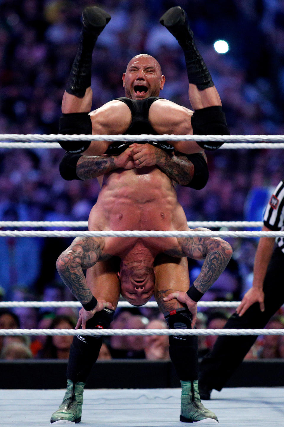 Randy Orton, bottom, and Batista, top, compete during Wrestlemania XXX at the Mercedes-Benz Super Dome in New Orleans on Sunday, April 6, 2014. (Jonathan Bachman/AP Images for WWE)