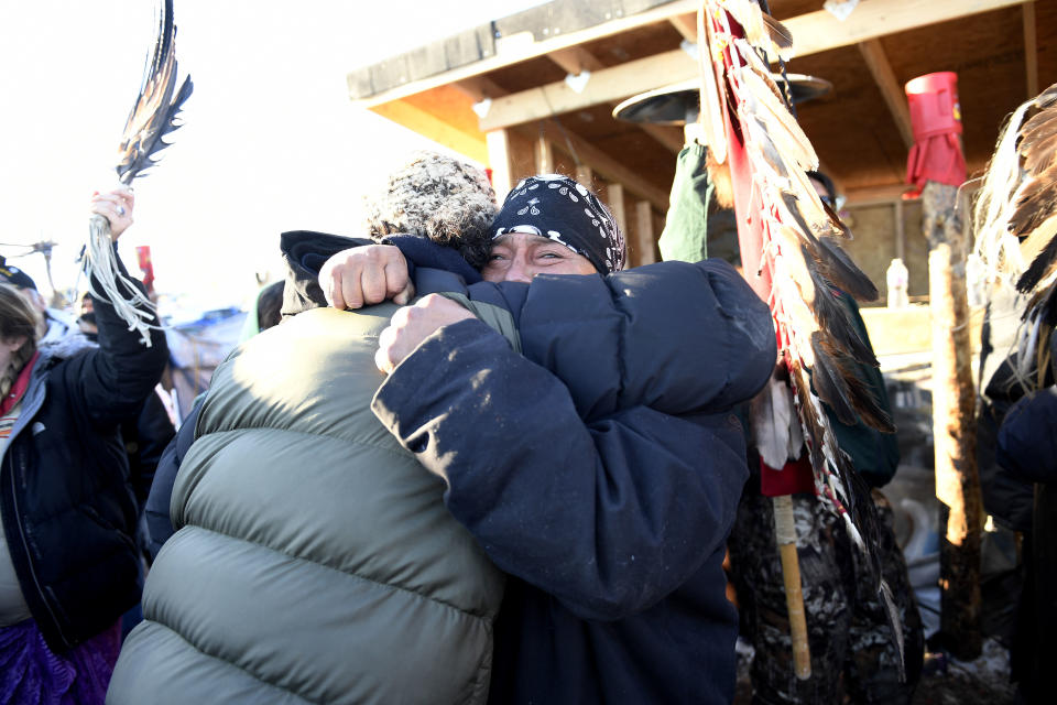 Troy Fairbanks, right, of the Standing Rock Sioux tribe, holds back tears as he hugs a friend after hearing Chief Arvol Looking Horse announce, to members of over 300 nations, that the US Army Corps of Engineers will no longer grant access to the Dakota Access Pipeline to put their pipe line on the boundary of the Standing Rock Sioux Reservation.