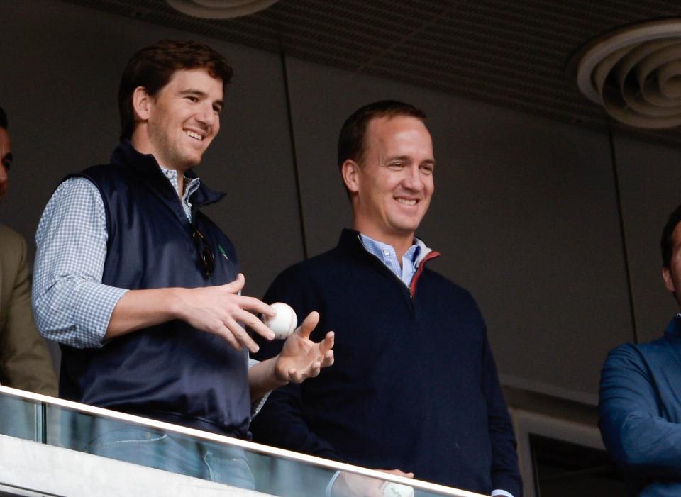 It surely appears former NFL QBs Eli Manning, left, and brother Peyton Manning have a rosy future in broadcasting.