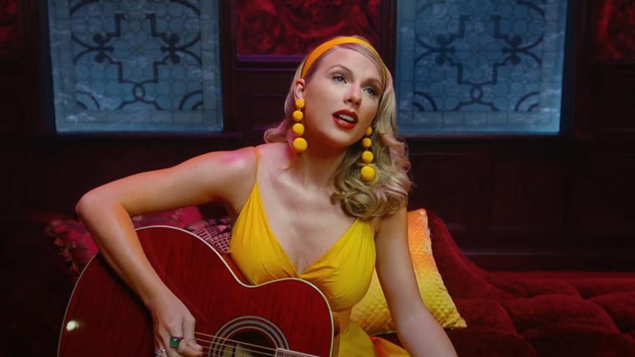  Taylor Swift in a yellow dress in the Lover music video. 