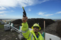 A Republic Services operator shots a blank into the air to keep wild birds off trash as Otay Compost mounds are being cured at the Otay Landfill in Chula Vista, Calif., on Friday, Jan. 26, 2024. Otay facility operates completely off the grid. A total of 144 solar panels generate power to the fans, sensors and other equipment utilized to operate the compost facility. (AP Photo/Damian Dovarganes)