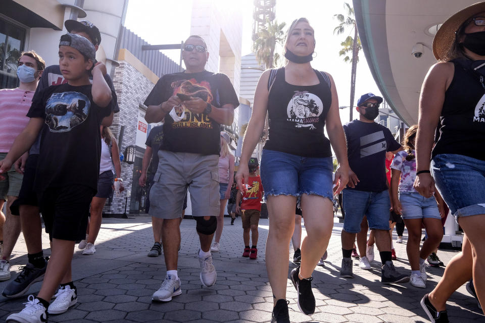 People arrive at Universal Studios in Universal City, Calif., Tuesday, June 15, 2021. On Tuesday, California lifted most of its COVID-19 restrictions and ushered in what has been billed as the state’s “Grand Reopening.” (AP Photo/Ringo H.W. Chiu)