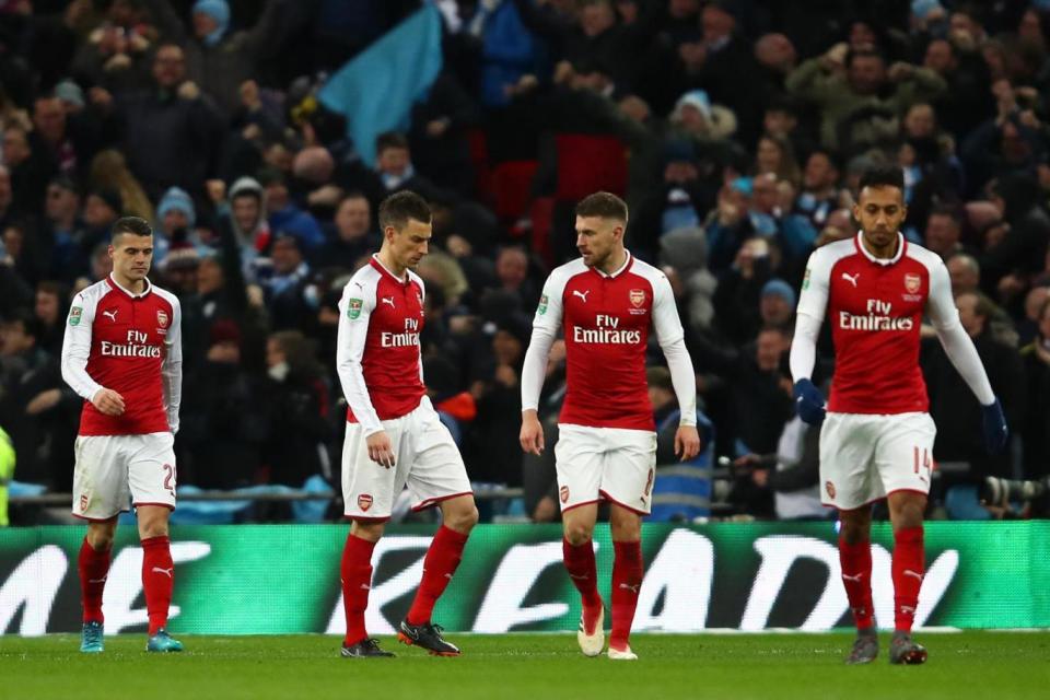 Dejected: Arsenal players react after David Silva's goal (Getty Images)