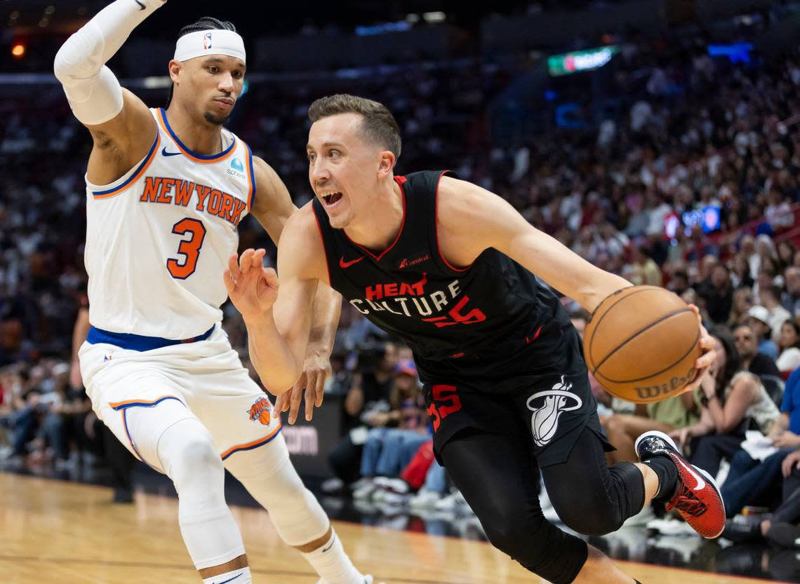 Miami Heat forward Duncan Robinson (55) drives the ball as New York Knicks guard Josh Hart (3) defends in the second half of their NBA game at Kaseya Center on April 2, 2024, in Miami.