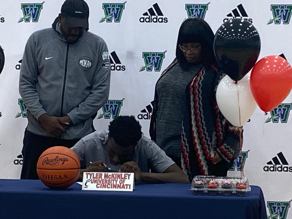 Tyler McKinley of Winton Woods signs to play basketball at UC. From left are brother Alex McGlothlin, Tyler McKinley and mother Arlinda McKinley.