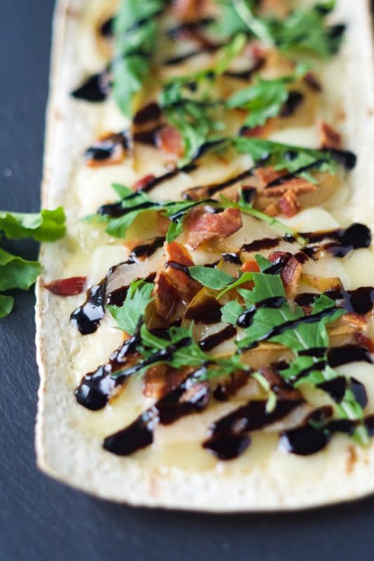<p>With Salt & Wit</p><p>This simple appetizer is filled with sweet, salty and savory flavors that can be on your table in 15 minutes! </p><p><strong>Get the recipe: <a href="https://withsaltandwit.com/pear-brie-and-bacon-flatbread/" rel="nofollow noopener" target="_blank" data-ylk="slk:Pear, Brie and Bacon Flatbread;elm:context_link;itc:0;sec:content-canvas" class="link ">Pear, Brie and Bacon Flatbread</a></strong></p>
