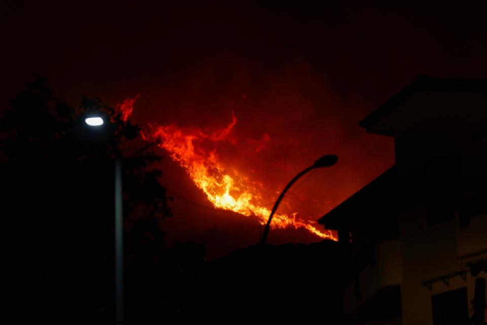 A wildfire burns in the Sicilian village of Romitello, near Palermo, Italy (REUTERS)