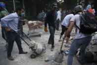 <p>Volunteers pick up the rubble from a building that collapsed during an earthquake in the Condesa neighborhood of Mexico City, Tuesday, Sept. 19, 2017. A powerful earthquake jolted central Mexico on Tuesday, causing buildings to sway sickeningly in the capital on the anniversary of a 1985 quake that did major damage. (AP Photo/Rebecca Blackwell) </p>