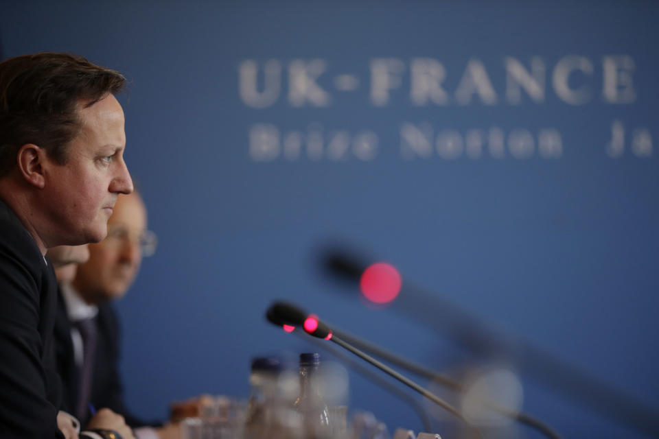 British Prime Minister David Cameron takes part in a plenary meeting with French President Francois Hollande in the Officer's Mess during their one-day summit at the RAF Brize Norton airbase in Brize Norton, England, Friday, Jan. 31, 2014. The one-day summit is expected to cover military cooperation, including talks over armed drones, anti-ship missiles, and underwater mine detectors, as well as a joint Franco-British force of 10,000 soldiers due to be formed in the next few years. (AP Photo/Matt Dunham, Pool)