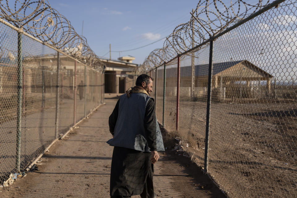 An afghan man walks at the Afghanistan-Iran border crossing of Islam Qala, on Wednesday , Nov. 24, 2021. Afghans are streaming across the border into Iran, driven by desperation after the near collapse of their country's economy following the Taliban's takeover in mid-August. In the past three months, more than 300,000 people have crossed illegally into Iran, according to the Norwegian Refugee Council, and more are coming at the rate of 4,000 to 5,000 a day. (AP Photo/Petros Giannakouris)